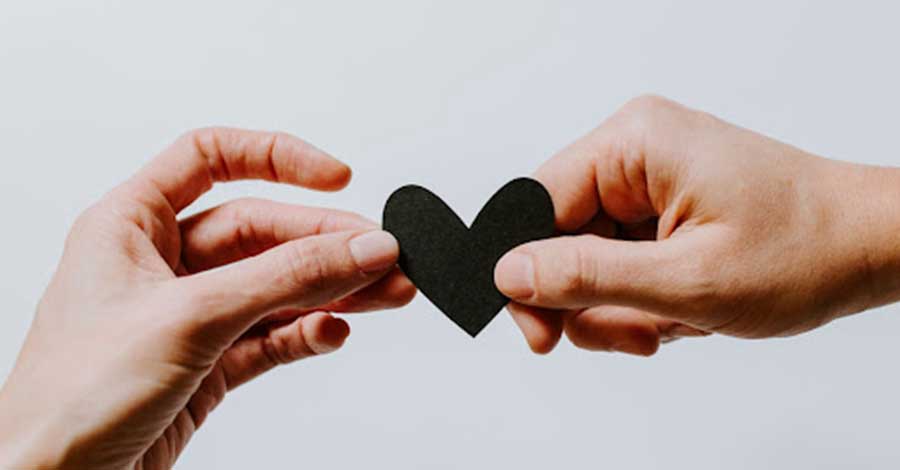 hands with paper heart